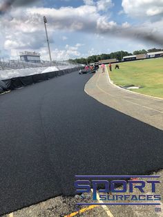 an empty race track with people on it