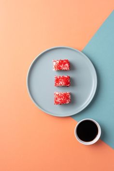 three pieces of cake on a plate next to a cup of coffee