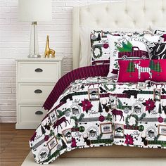 a white bed with red and green christmas decorations on the comforter, pillows and pillow cases