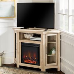 an entertainment center with a fireplace and flat screen tv on it's stand in front of a window