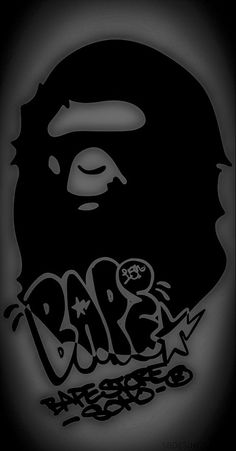 a black and white photo of a gorilla head with graffiti on it's face