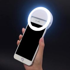 a person holding an iphone in their hand with a light up phone case on it