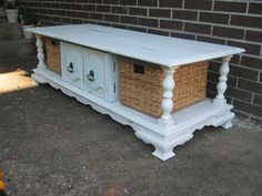 a white table with two baskets on it and a brick wall in the back ground