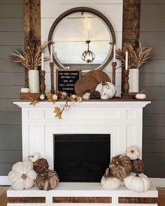 a fireplace with white pumpkins and other decorations