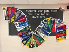 a bulletin board with flags hanging from it's sides in front of a chalkboard