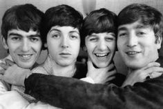 the beatles posing for a photo together