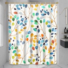 a shower curtain with colorful leaves on it