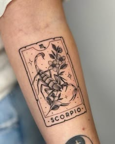 a black and white tattoo on the arm of a person with a scorpio