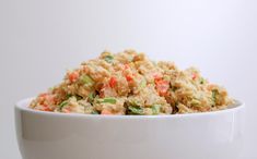 a white bowl filled with rice and vegetables