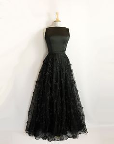 "This stunning full length bridal overskirt is made from our beautiful 3D Peggy Lace. It is a generous full-circle skirt with an extra layer of tulle underneath for extra volume and a high fitted waistband in satin crepe. It is seen here in a dramatic black but can also be made in ivory. Photographed in black with the Elvira Wedding Gown in Black Satin Crepe: https://www.etsy.com/uk/listing/1403872161/elvira-wedding-gown-in-black-satin-crepe?click_key=75e96a7c5c1443f514a630a1b8cd8b2087eaa4a8%3A1 Elegant Floor-length Ball Gown With Tulle Skirt, Full Length Party Dress With Tulle Skirt, Full Length Tulle Skirt Party Dress, Full-length Tulle Dress For Party, Full Length Tulle Dress For Party, Full Length Tulle Skirt Dress For Party, Black Evening Dress With Full Skirt For Gala, Black Full Skirt Evening Dress For Gala, Black Full Skirt Wedding Dress