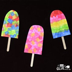 three popsicles made out of paper and colored tissue paper are shown in the shape of rainbows