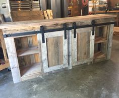 a kitchen island made out of wood with sliding doors on the front and back sides