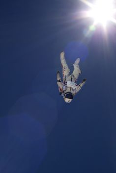 the sun is shining brightly over a snowboarder in mid air