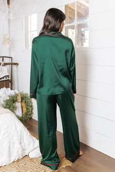 Our Dreamy Green & Red Satin Pajama Set is the epitome of holiday comfort with a touch of elegance! Designed in luxurious satin, this set features a long-sleeve, collared V-neck top with a button-down front and contrast red seam details for a festive flair. The wide-leg pants include an elastic waistband and adjustable drawstring for a perfect fit. With its soft and smooth fabric blend, this set offers ultimate relaxation and style. Also available in red, these holiday pajamas are perfect for cozy nights and festive mornings! Fall Style Guide, Satin Pajama Set, Pajama Outfits, Satin Pajama, Loungewear Dresses, Casual White Dress, Holiday Pajamas, Holiday Tops, Satin Pyjama Set