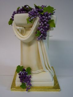 a figurine with grapes growing out of it