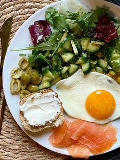 a plate with an egg, bread and vegetables on it