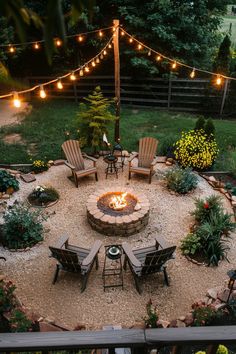 a fire pit surrounded by lawn chairs and string lights in the middle of a yard