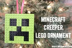 a lego ornament hanging from a christmas tree with the words minecraft creeper on it