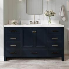 a white toilet sitting next to a blue vanity with two sinks and mirrors above it