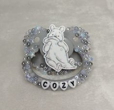 a brooch with a bear and name on it