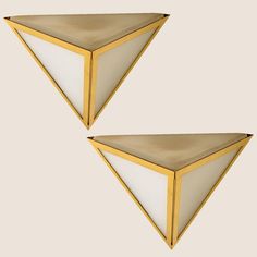 two gold and white triangular shaped wall lights