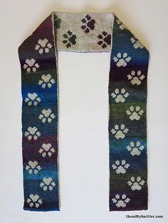 a knitted scarf with paw prints on it