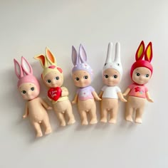 five little dolls are lined up in the shape of bunnies