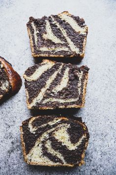 four slices of zebra print brownies on top of each other next to a loaf of bread