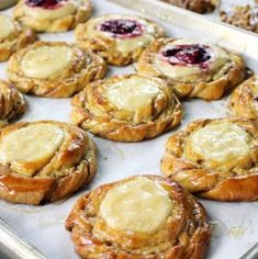 many pastries are sitting on a baking sheet