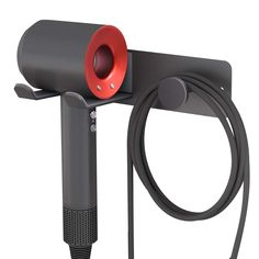 a black and red object is attached to a metal pole with a hose connected to it