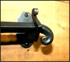 a close up of a metal hook on a wooden door