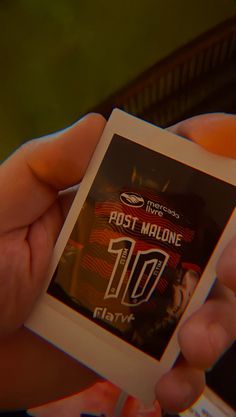 a person holding up a card with the number 10 on it in their hands,