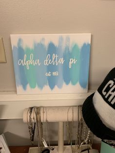 a blue and white sign sitting on top of a counter next to a pair of glasses