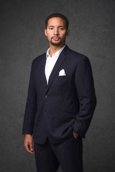 a man in a suit posing for a photo