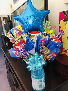 a blue star vase filled with candy and candies sitting on top of a table