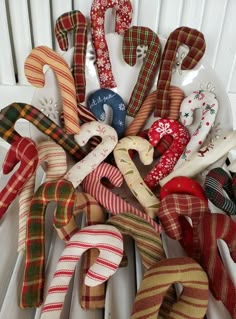 a pile of assorted christmas ribbon and ornaments on a white plate with the word love spelled out