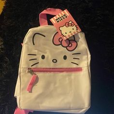 a hello kitty bag with a pink ribbon around it