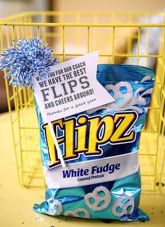 a bag of flips sitting on top of a table next to a yellow basket