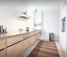 a kitchen with wooden cabinets and white walls