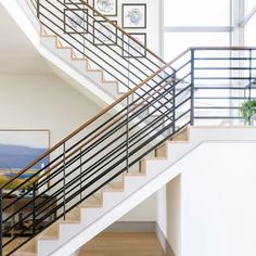 there is a staircase in the house with pictures on the wall