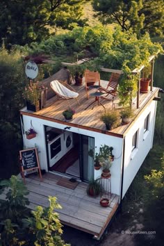 an elevated deck with chairs and plants on the roof is perfect for this tiny house