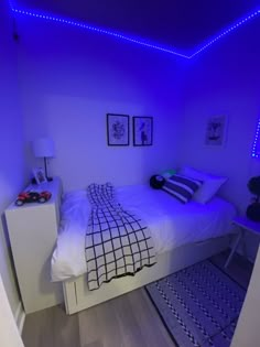 a bedroom with blue lights on the ceiling