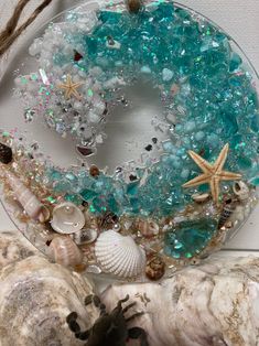 there is a glass plate with shells and starfishs on the wall next to it