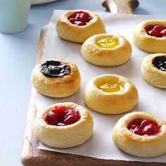 small pastries with jelly and jam are on a tray