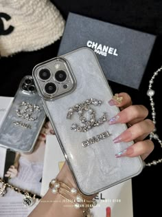 the chanel phone case is on display in front of a woman's hand