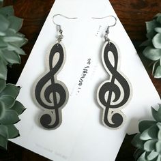 a pair of earrings with musical notes on them