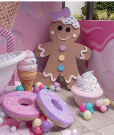 an ice cream cone, cupcakes and doughnuts are on display