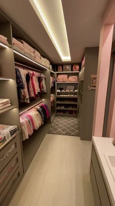 a walk in closet filled with lots of clothes