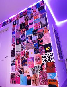 a wall covered in photos and pictures with purple lighting on it, next to a white door