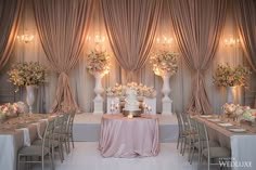 a wedding reception setup with pink and white decor